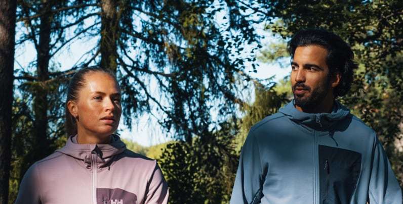 Man and woman in the forest, wearing Helly Hansen Fleece