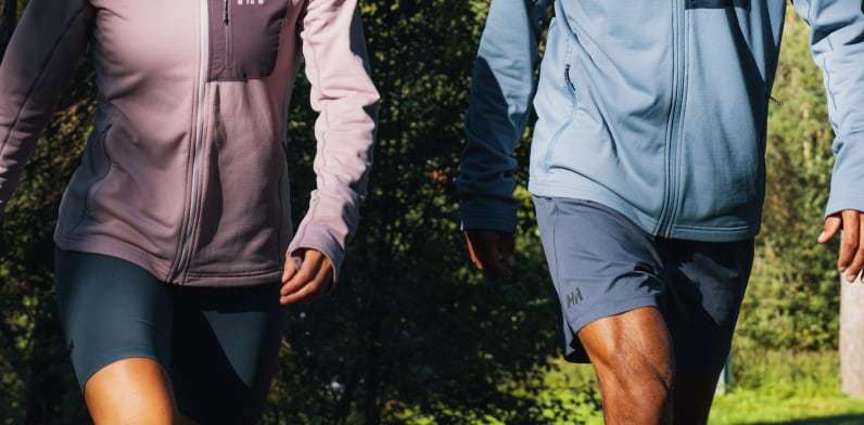 Man and woman in the forest, wearing Helly Hansen Fleece