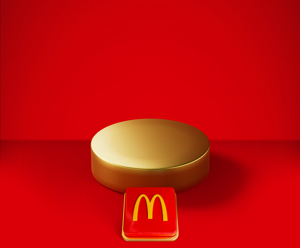 An appetising McDonald's meal sits on a gold plinth. Celebratory gold icons explode out. Text reads SAVE 15% WHEN YOU SPEND £15 ON FOOD OR DRINK