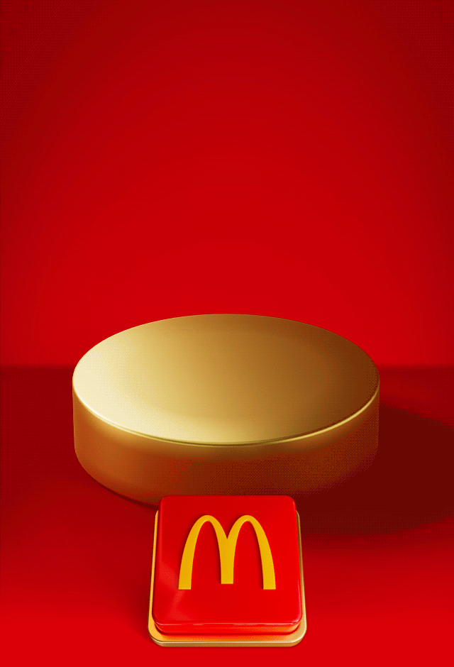 An empty gold plinth sits on a red background with a big red button beneath it. Text reads TAP TO REVEAL MONDAY'S DEAL