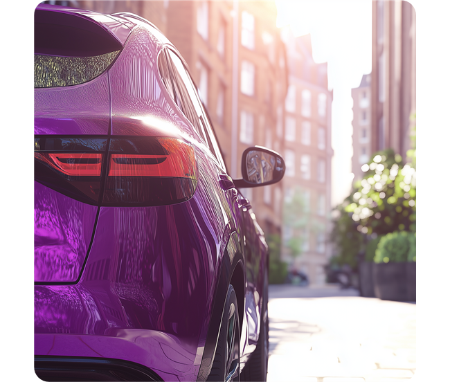 A purple car driving through a town