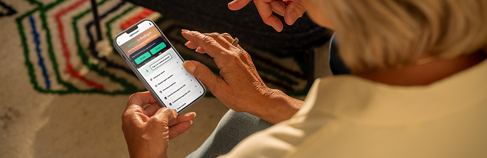 A person on their phone, using the Rightmove mobile app