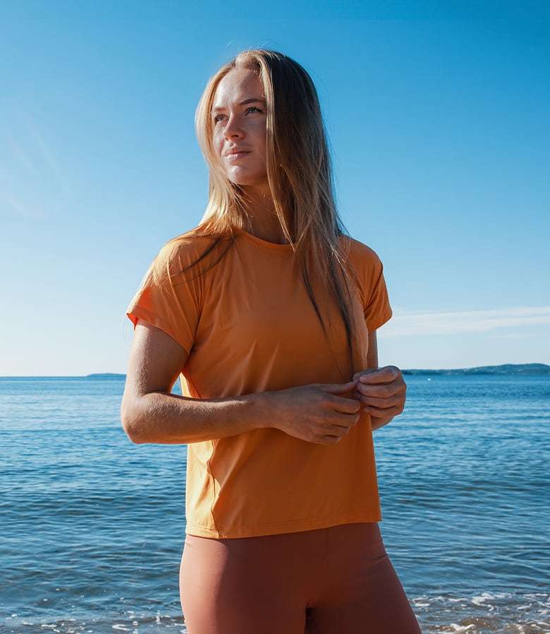 Woman outside in the sunshine, wearing Helly Hansen sun protective T-Shirt