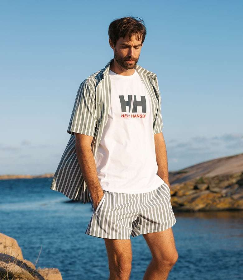 Man wearing Fjord Quick-Dry Short Sleeve Shirt 2.0 by the ocean