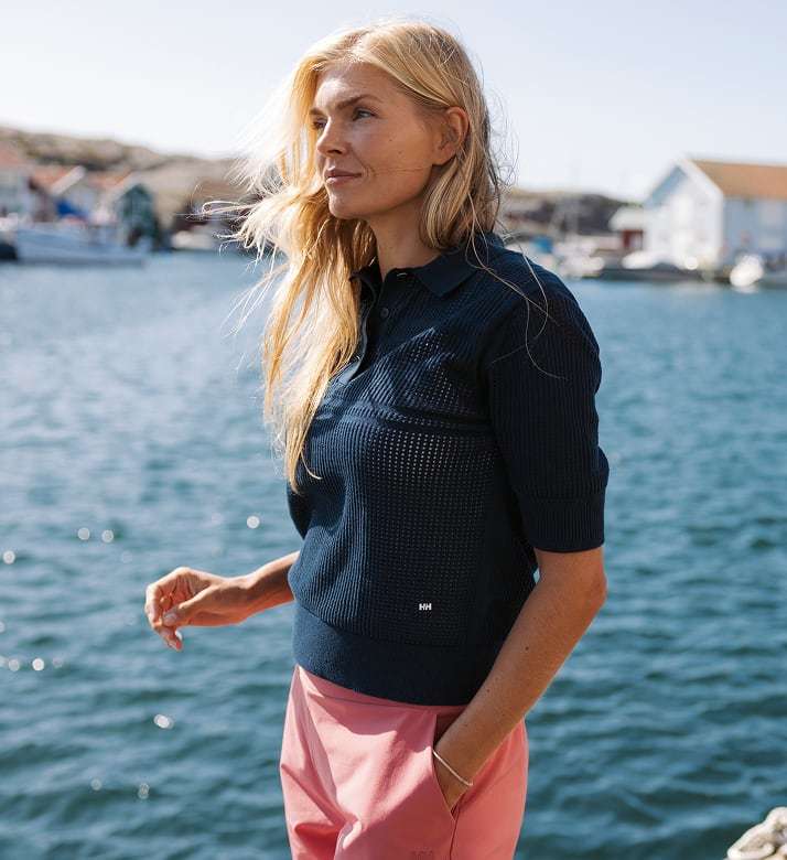 Woman wearing Helly Hansen gear by the ocean