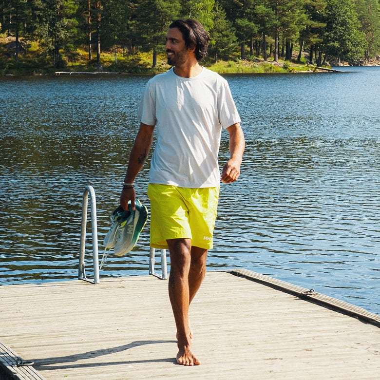 Man wearing Helly Hansen swimwear by the lake