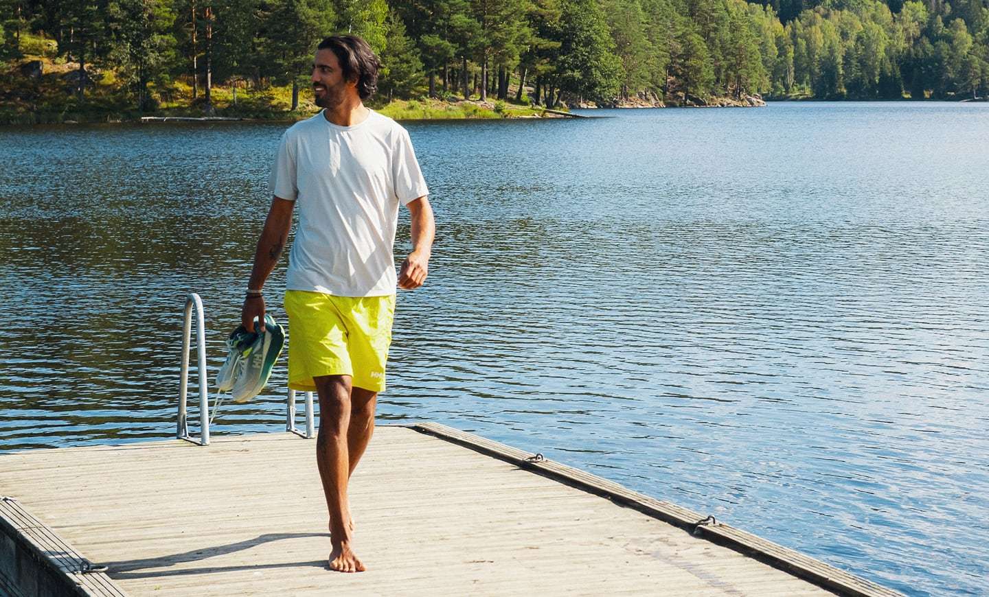 Man wearing Helly Hansen swimwear by the lake