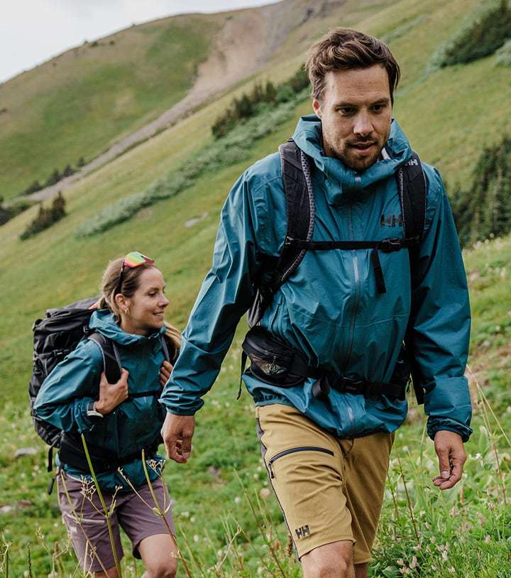Man and woman hiking in Helly Hansen gear