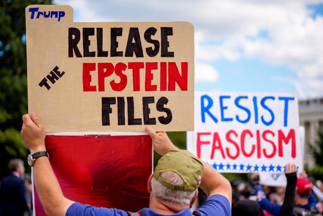 A protester holds up a sign reading 'Trump, release the Epstein files'