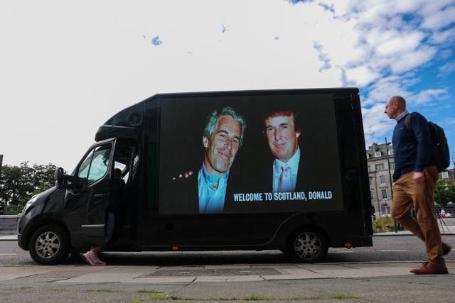 A van bears an image of Donald Trump and Jeffrey Epstein