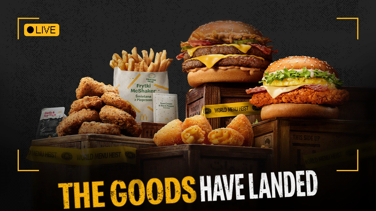The heisted world stash displayed on top of wooden crates. Bold text reads 'The goods have landed'.