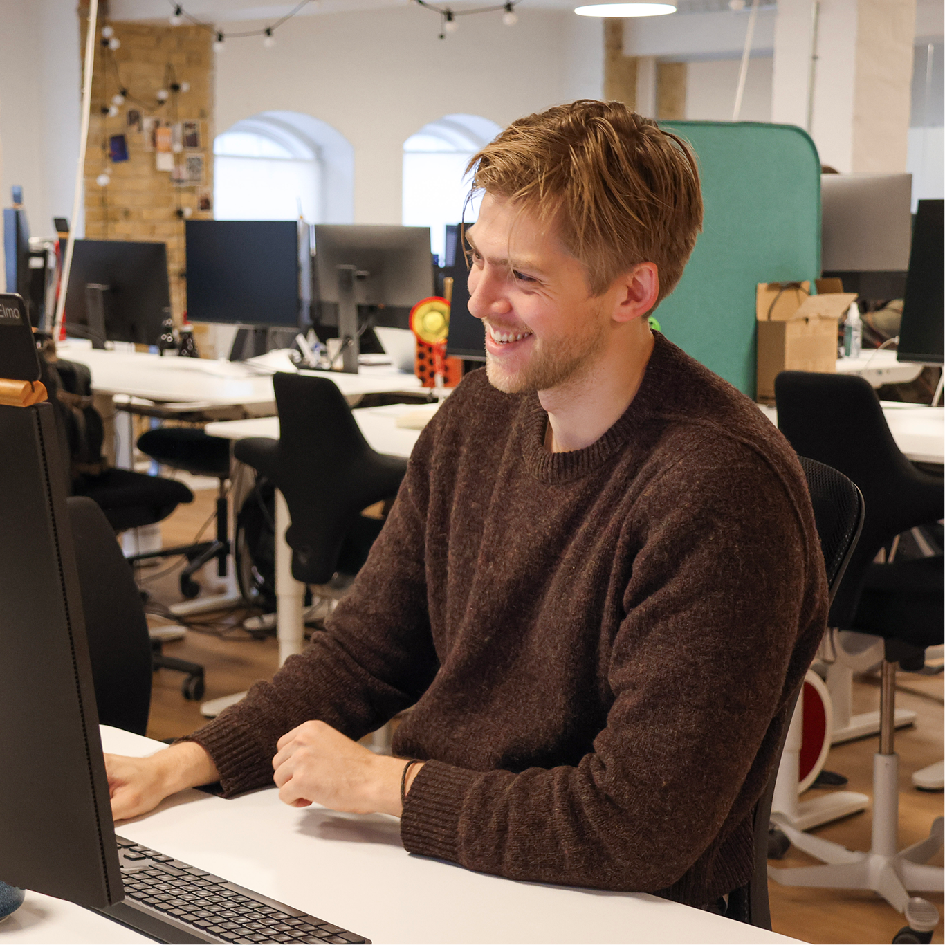 image of 2 people sitting by the table and smiling