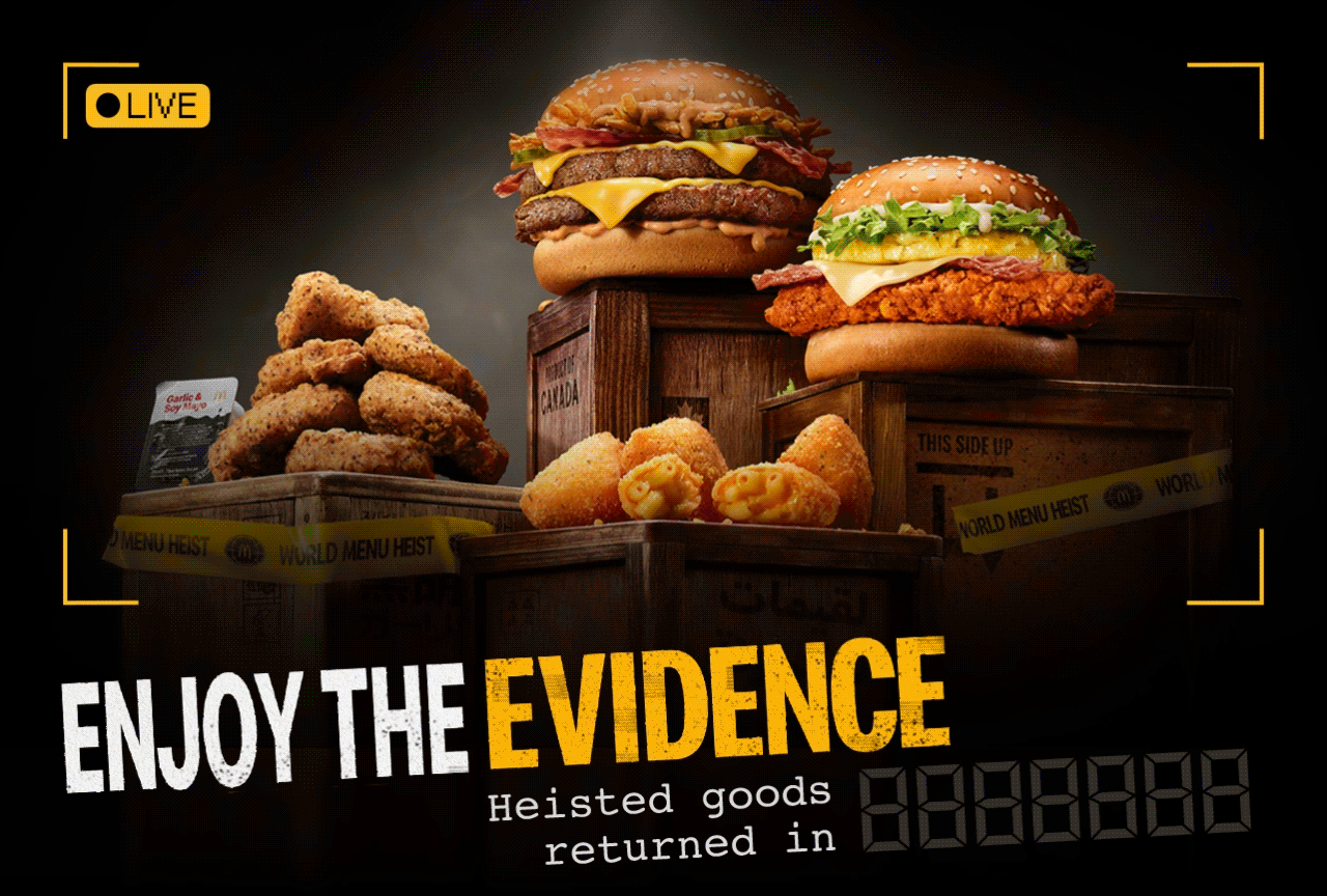 Animated GIF with the heisted menu items placed upon crates. Bold text reads 'Enjoy the evidence. Heisted goods return in 6 days'. The image then flickers and the heisted food disappears.