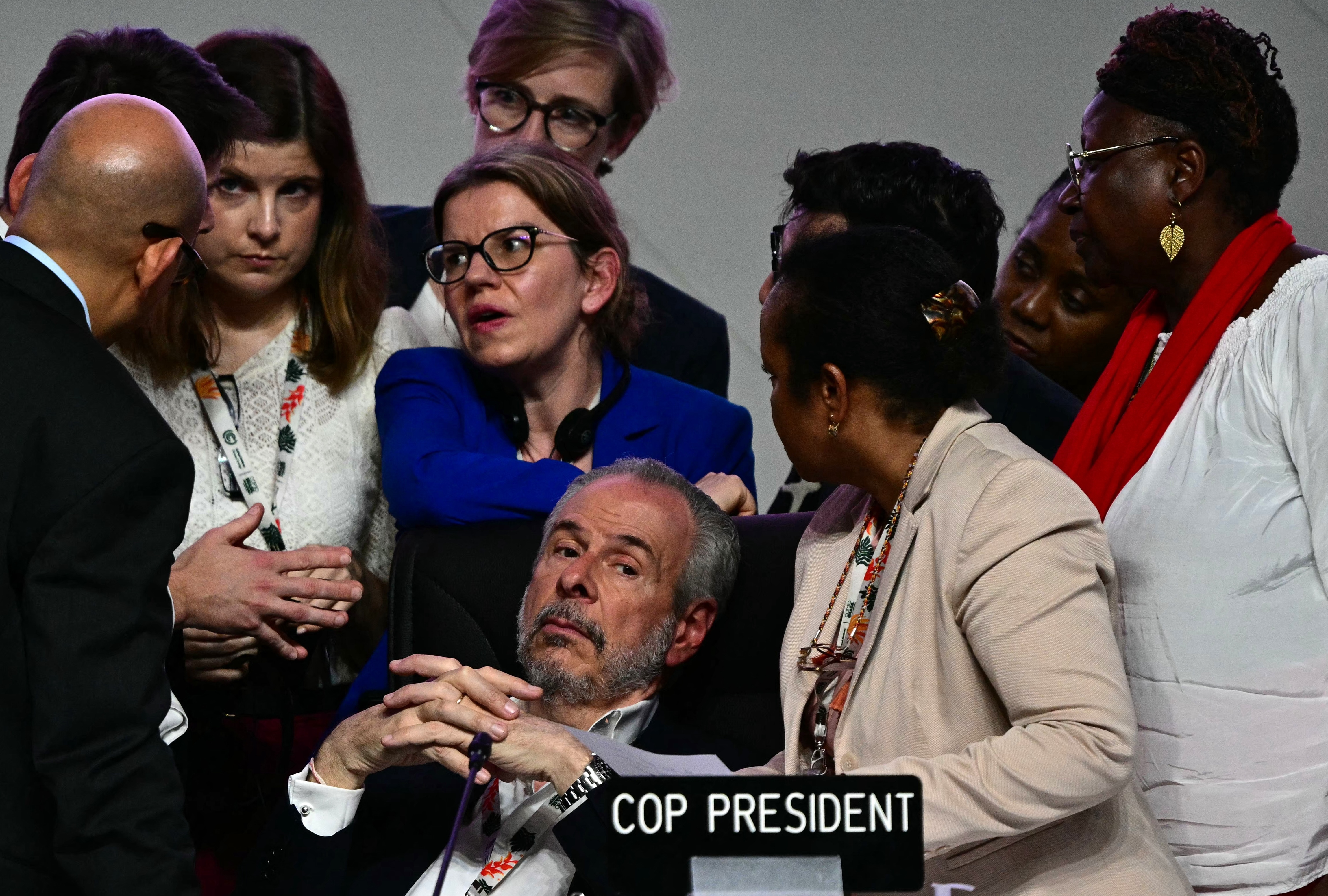 COP30 President Andre Correa do Lago, center, listens to his advisers next to United Nations Climate Change Executive Secretary Simon Stiell, left, at the COP30 UN Climate Change Conference in Belem, Brazil, on November 22, 2025