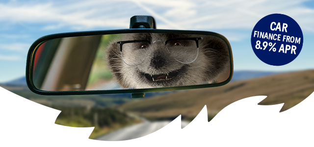 Sergei reflected in a car rear-view mirror for car finance.