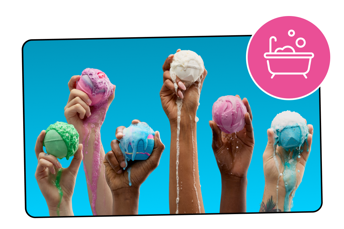 Hands holding up fizzing bath bombs