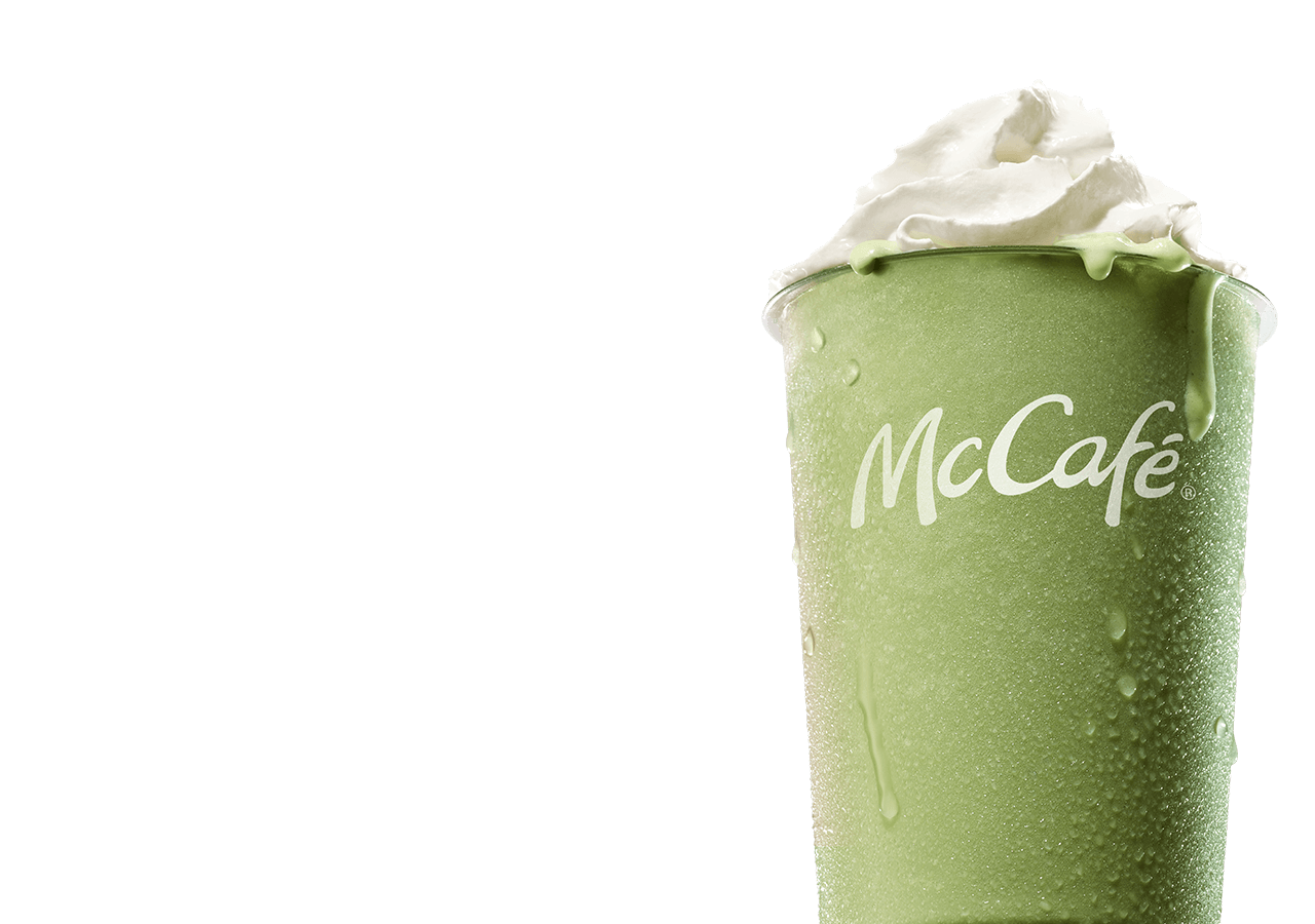 An icy, refreshing matcha latte on a blue-pink gradient background. As you scroll down the page, large white text is revealed reading 'Make it a matcha summer. Matcha blended with ice, topped with whipped cream, sweetened with vanilla'.