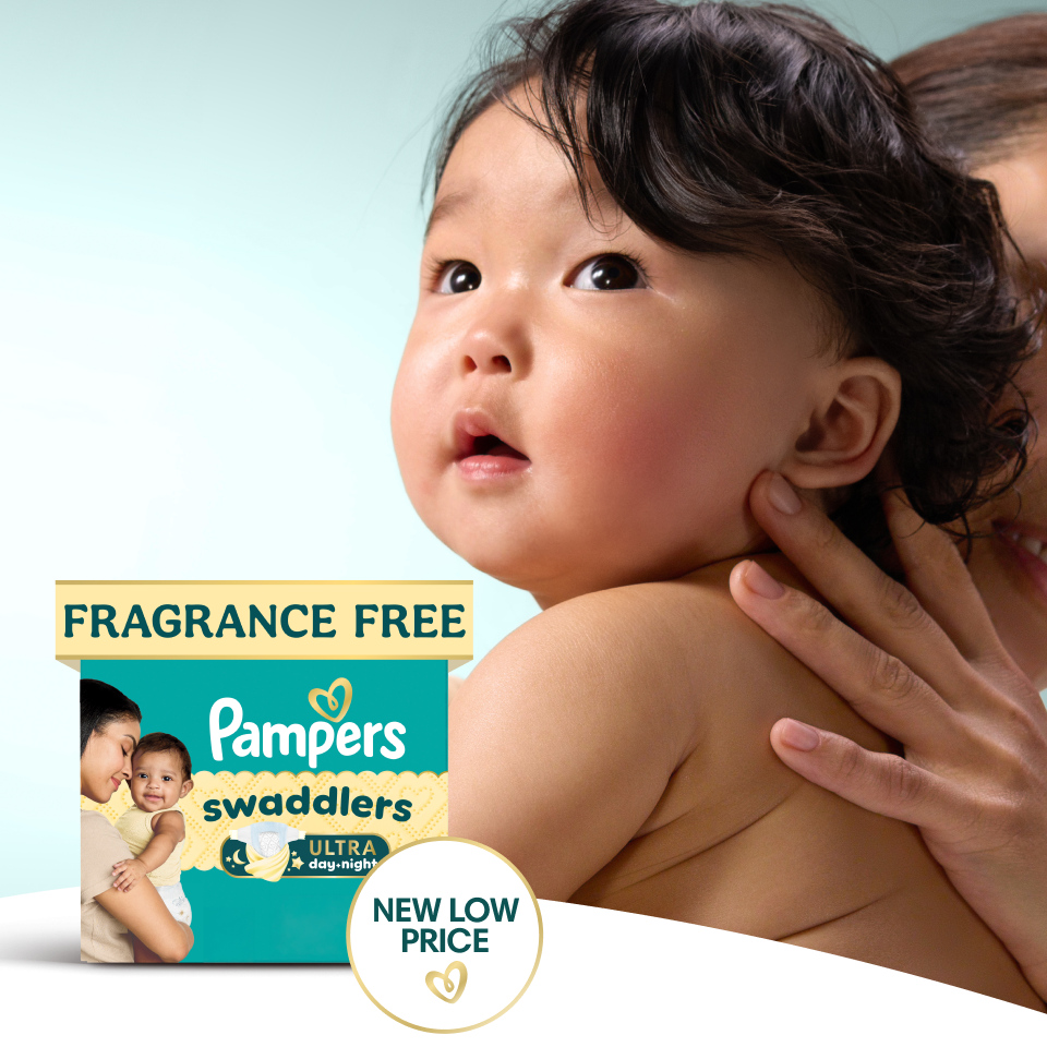 Close-up image of a baby’s face as it looks onward with an inquisitive expression. In front of this image, there’s a pack of Pampers Swaddlers and a badge that reads, “NEW LOW PRICE”.
