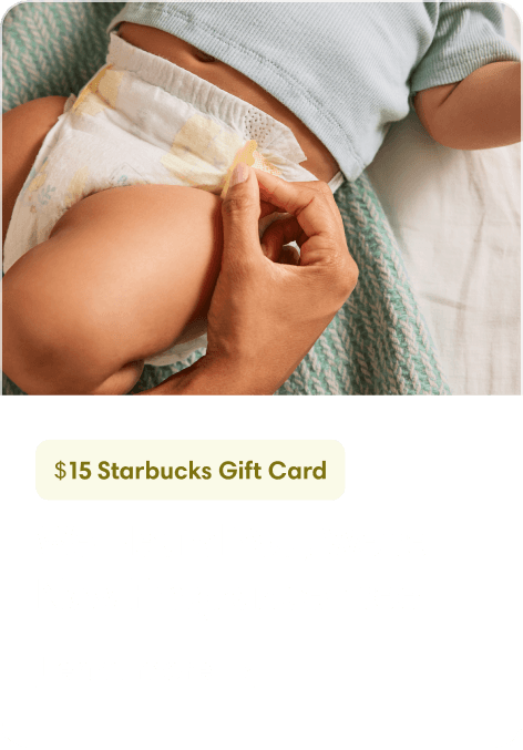 there’s a parent’s hand adjusting their baby’s diaper.