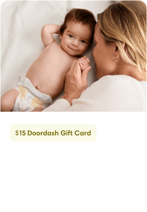 a mother looks lovingly at her smiling baby.