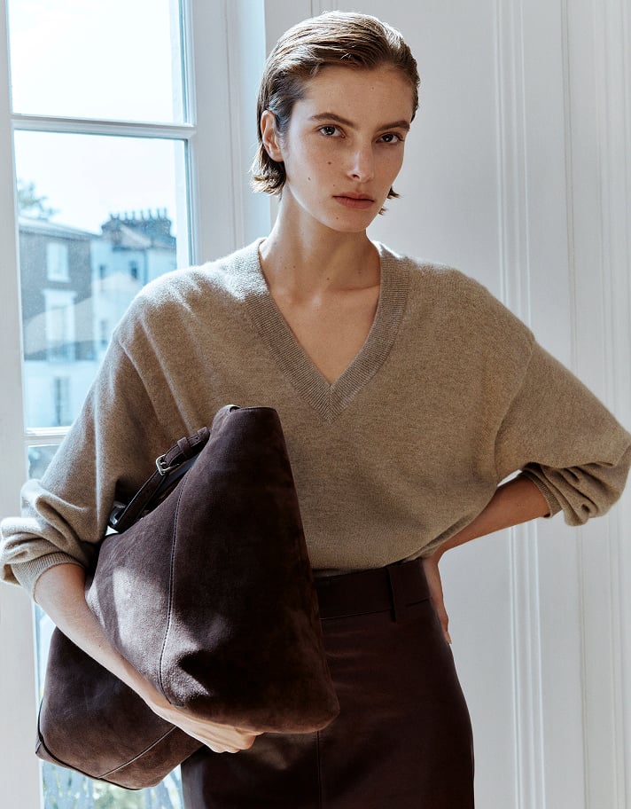 A luxurious knit tempered with a sleek pencil skirt strikes the perfect smart/casual balance